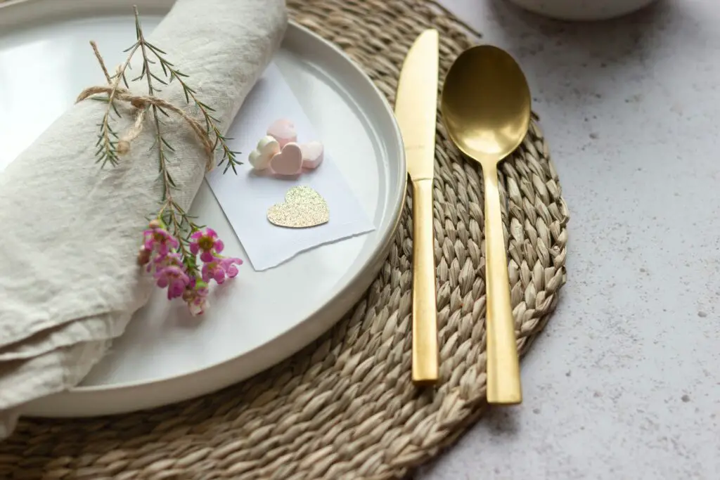redfin valentine's day article. place setting with gold silverware. 