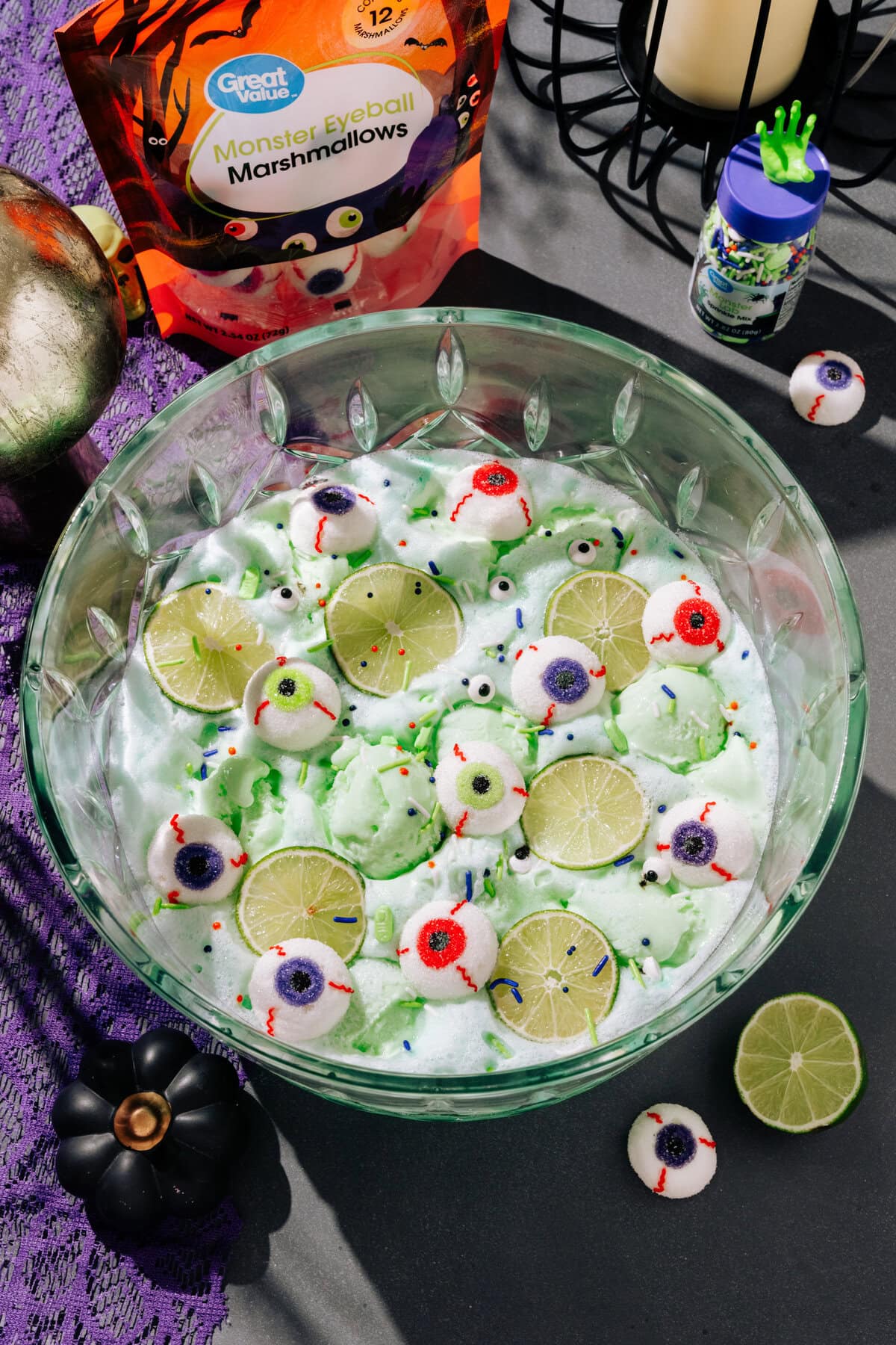 Overhead view of punch bowl filled with lime sherbet, light green punch, with eyeball marshmallows.