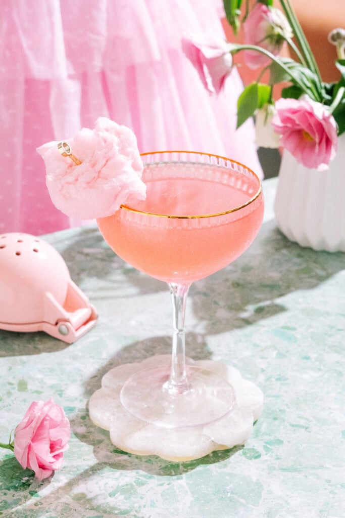 Pink oz-mopolitan wicked cocktail with cotton candy garnish