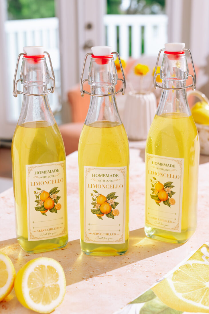 3 Bottles of homemade limoncello recipe with labels with lemons