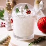White Snow Globe Margarita topped with a clear dome, mini snowman, rosemary trees, and a gingerbread figure.