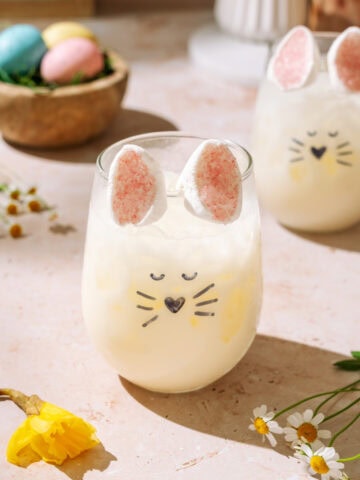 Easter Bunny Spritz creamsicle cocktail with bunny marshmallow ears in a festive Easter glass.