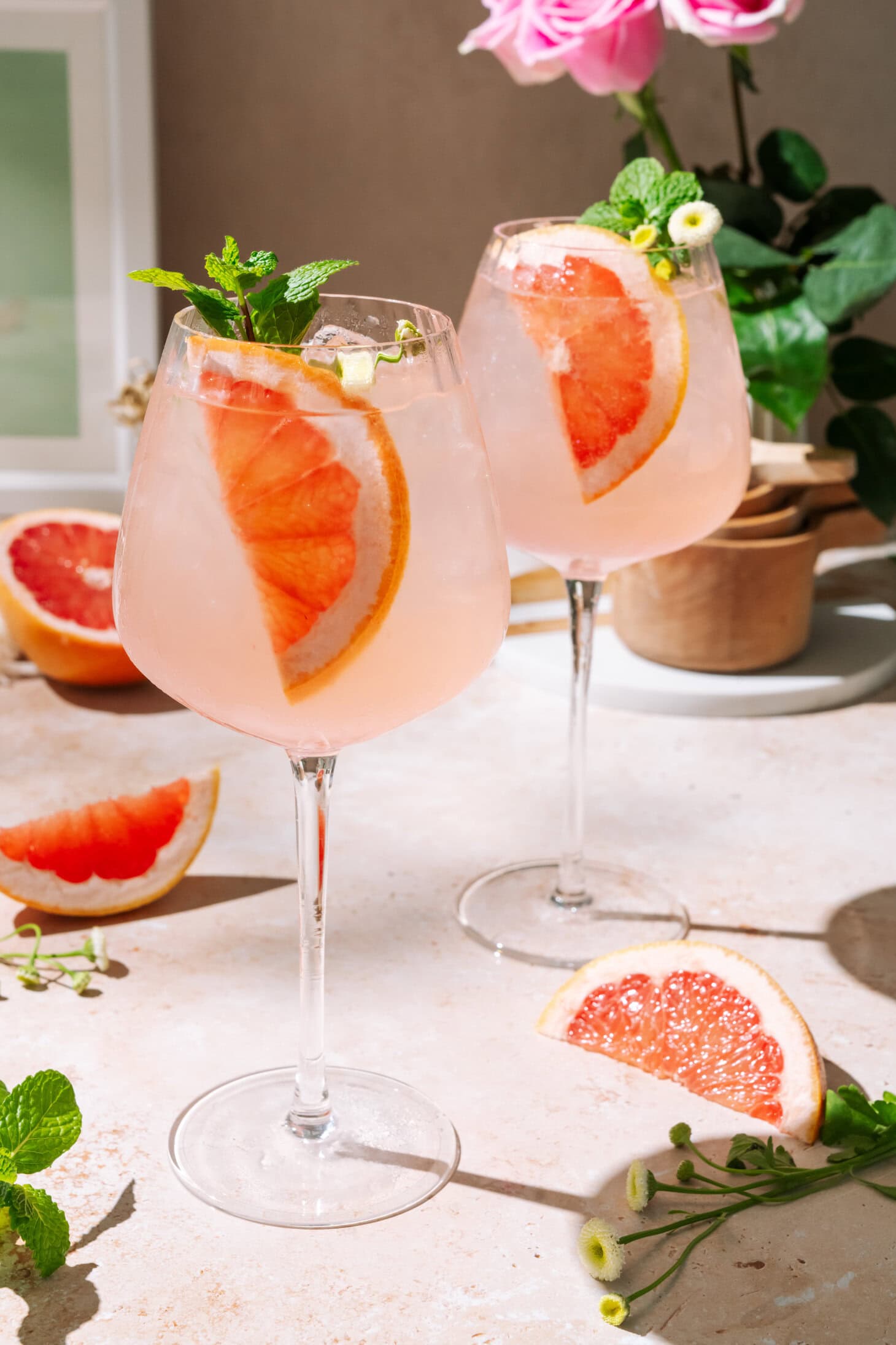 Elderflower Grapefruit Spritz cocktail with fresh grapefruit garnish in a wine glass.