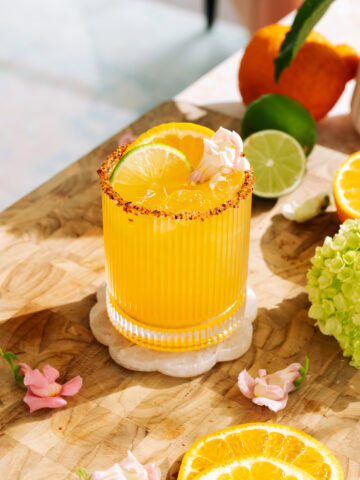 Refreshing hot honey citrus mockarita with sumo orange, lime, and chili sugar rim on ice