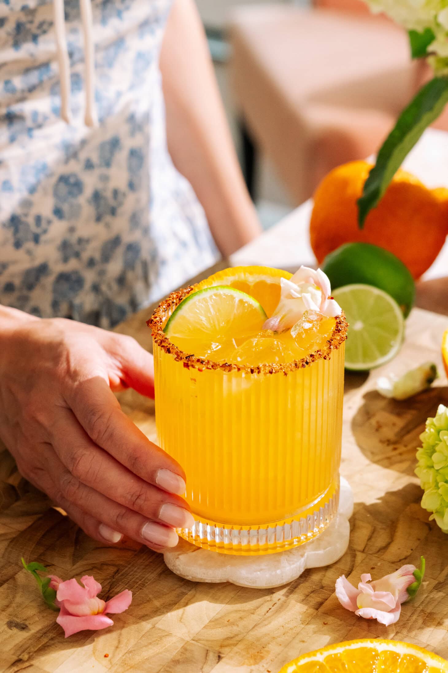 Refreshing hot honey citrus mockarita with sumo orange, lime, and chili sugar rim on ice